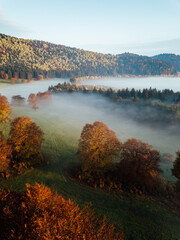 Majestic sunrise over autumn mountains at sunrise. Foggy forest from above. 