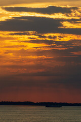 Amazing sunrise on the water of Amazon river in Brazil, nice soft warm light seeping through the clouds