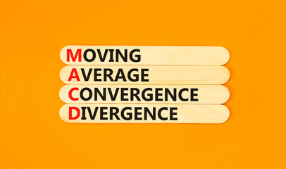 MACD symbol. Concept words MACD moving average convergence divergence on wooden stick on beautiful orange background. Business MACD moving average convergence divergence concept. Copy space.