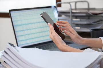 Marketer or analytic manager team dressed in suits working with paper charts and laptops at the meeting room.