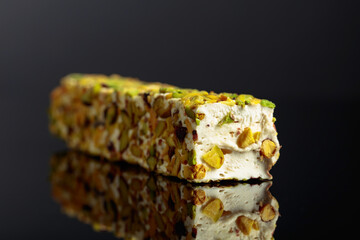 Turkish delight on a black reflective background.