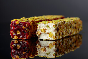 Turkish delight on a black reflective background.