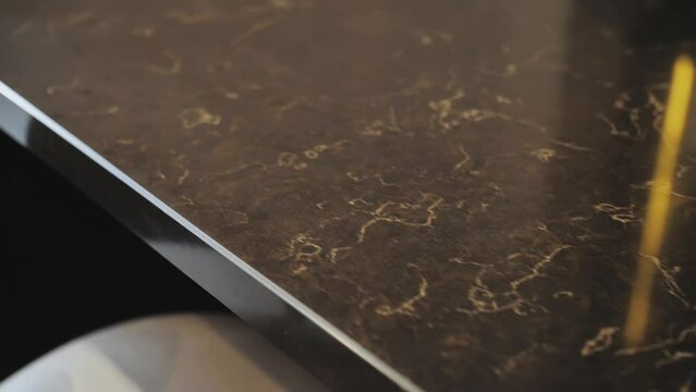 Close-up shot of beautiful granite black counter top, camera moving slow motion. Kitchen design with counter top made of granite stone.
