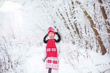 Portrait of happy young woman in winter forest