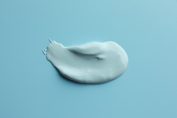 Sample of face mask on light blue background, top view