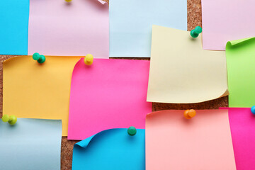 Many empty colorful notes pinned to cork board