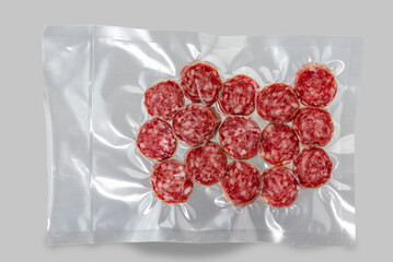 Sausage salami slices in vacuum packed sealed for sous vide cooking isolated on Gray background in top view - obrazy, fototapety, plakaty
