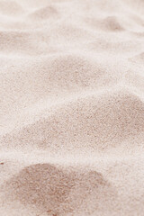 Pink Sand texture natural background. Close up sandy beach  sand on shore sea, waves textured dunes, minimal nature vertical fon. Summer and travel, spa and rest concept. Selective focus