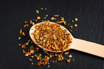 wooden spoon with seasoning on black board