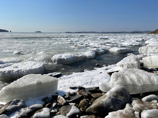 Blocks of ice off the coast of Patroclus (Patrokl) Bay at the end of winter. Russia, Vladivostok city