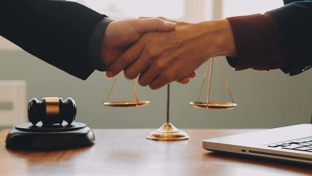 Business and lawyers discussing contract papers with brass scale on desk in office. Law, legal services, advice, justice and law concept picture with film grain effect