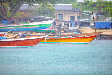 Heavy rain droplets and colorful fishing boats
