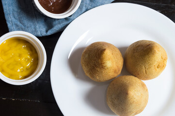 Three dumplings called coxinha photographed from above