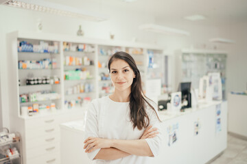 Health care professional woman working at a pharmacy drugstore.Friendly pharmacist ready to give...