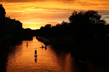 Stand up paddling at sunset on Avon River in Bath, England Great Britain