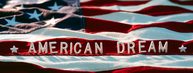 Small letters on the US flag. American dream concept background