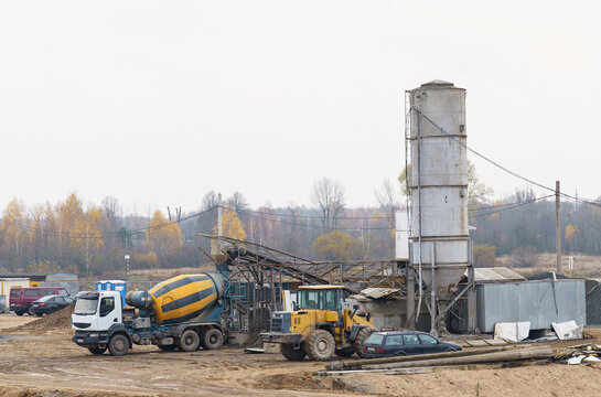 A concrete mixer stands at a modern concrete plant on loading