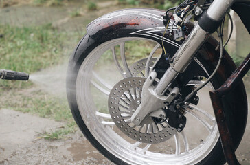 Washing a Harley-Davidson motorcycle with a high-pressure jet.