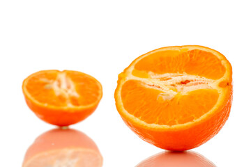Two halves of sweet organic tangerine, macro, isolated on white background.