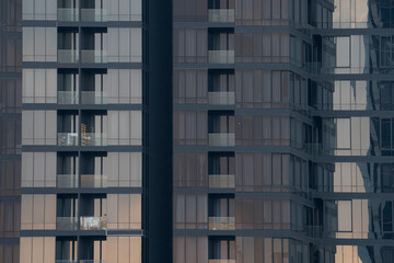 Fototapeta na wymiar Modern Glass facade of High Rise Apartment Buildings in City