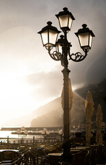 lamppost of the amalfi coast against sunset in rainy day