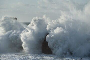 Large winter waves crash at Playa de la Arnia, Cantabria, Spain