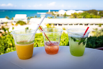 Tropical cocktails in compostable plastic cups and with paper straws