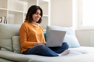 Online Communication. Portrait Of Beautiful Young Arab Woman Using Laptop At Home