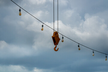Cloudy sky with lamps and hook