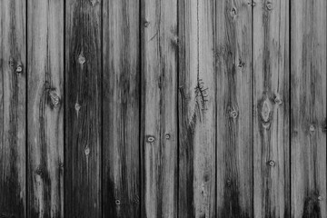 Vertical black and white vintage weathered textured stained wood panel wall for background texture in any abstract scene