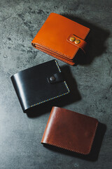 Black and brown men's wallet made of genuine leather. Handmade black men's wallet. - obrazy, fototapety, plakaty
