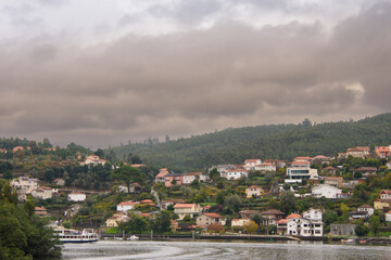 Fototapeta na wymiar The Douro, river of Portugal, with its cruise ships and its stepped hills