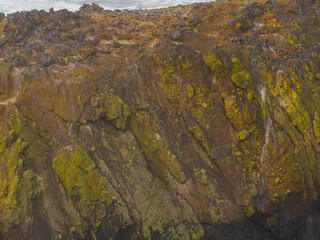 Stone shore covered with green moss. Minimalism. Abstraction. Geology, geography, ecology. Climate change, global warming. Background, texture.