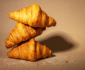 Croissants stack composition, French puff sweet dough bakery. Morning food on kraft paper