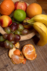 Trough with varied fruits, in warm tones on rustic table