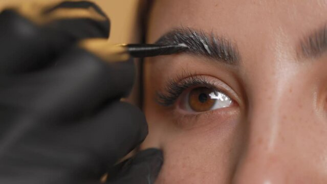 Woman does the eyelashes of a young lady.Beauty salon.Close-up.