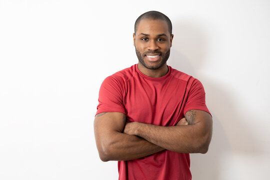 Handsome african american man with shaved hair dressed casually with happy face smiling with crossed arms looking at camera. positive person,optimism concept.