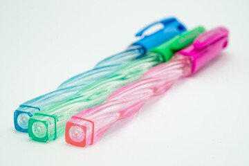 three color pens on white background