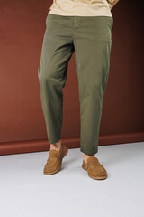 Male feet in brown suede casual shoes. Men's fashionable shoes
