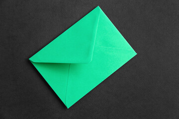 Green paper envelope on dark background