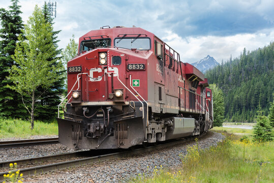 Field, BC, Canada - June 23, 2016; Canadian Pacific freight train in closeup on curve with red engine