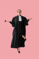 Young female judge with gavel jumping on pink background