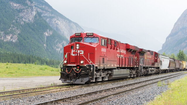 Field, BC, Canada - June 23, 2016; Canadian Pacific freight train with red engine in mountains