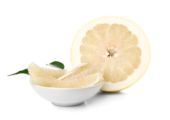 Half of sweet pomelo fruit and bowl of slices on white background