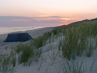 Tent on the Baltic  Sea beach on Sunrise  - 558233737