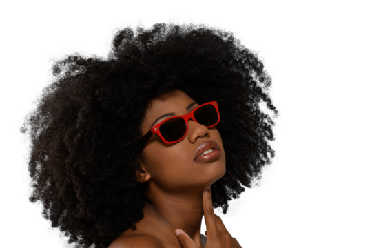 black woman looking up wearing red sunglasses on beige background, close-up portrait