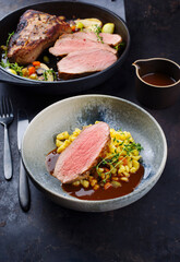 Tafelspitz Braten vom Kalb mit schwäbischen Spätzle serviert mit Dunkelbier Sauce als close-up in einem Design Schale und Topf  