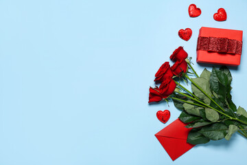 Red roses, envelope, gift and hearts on blue background. Valentine's Day celebration