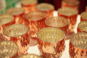 Golden glass candlesticks and tealight holders in the home decor store for retail sale