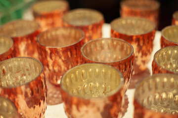 Golden glass candlesticks and tealight holders in the home decor store for retail sale